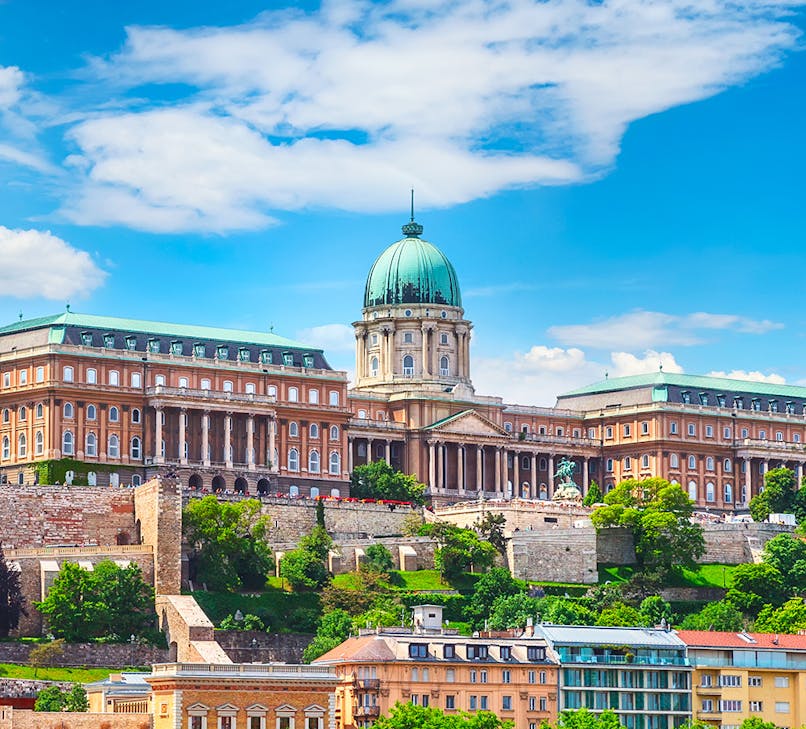 Buda Castle in Budapest with tourists exploring the historic architecture.