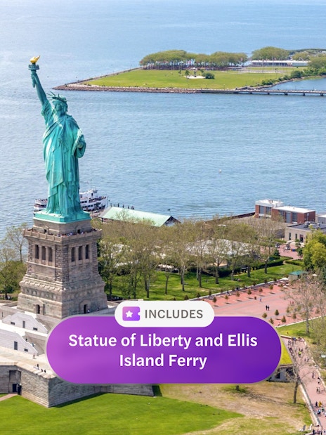 Statue of Liberty on Liberty Island, New York City, with Ellis Island ferry nearby.