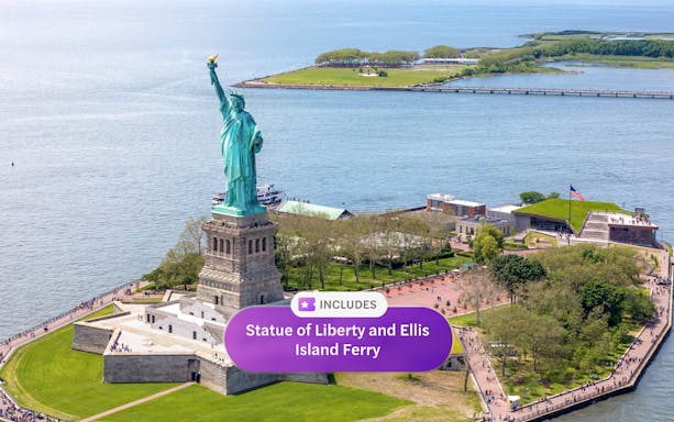 Statue of Liberty on Liberty Island, New York City, with Ellis Island ferry nearby.