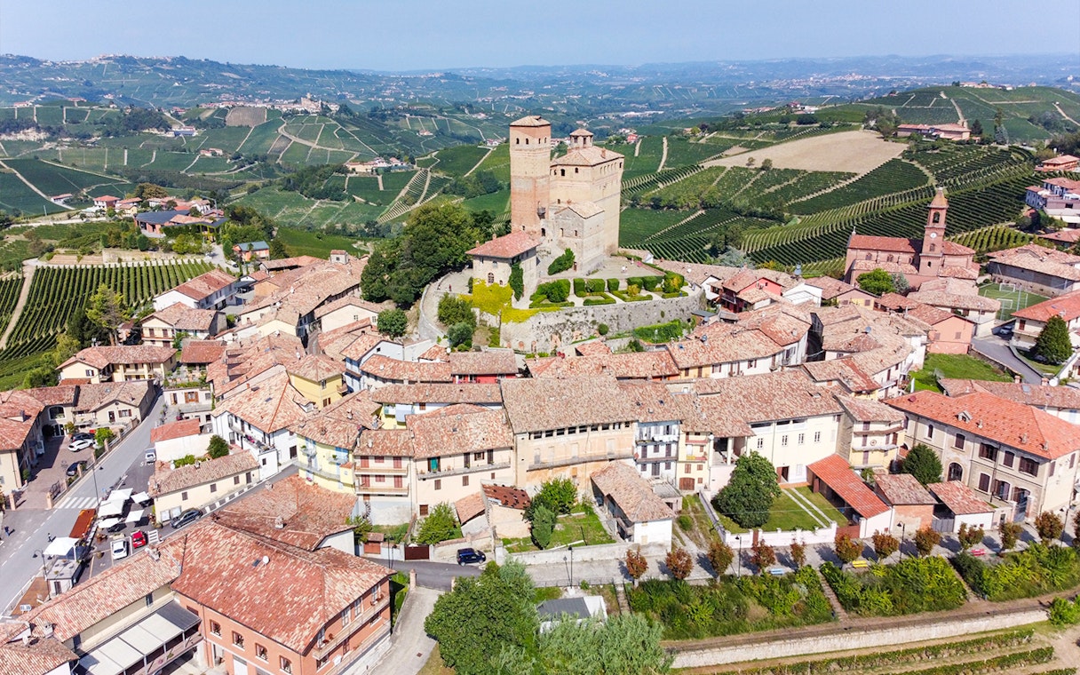 Aerial view of a historic castle and village in the vineyards of Piemonte, Italy.