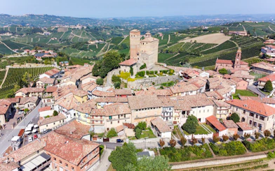 Aerial view of a historic castle and village in the vineyards of Piemonte, Italy.