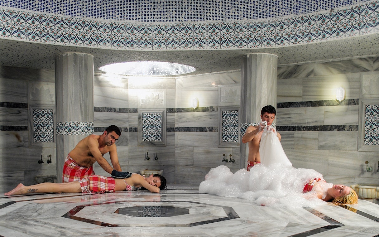 People enjoying traditional treatments inside Hammam Bath and Spa in Cappadocia.