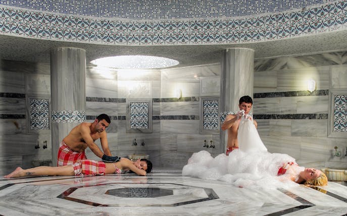 People enjoying traditional treatments inside Hammam Bath and Spa in Cappadocia.