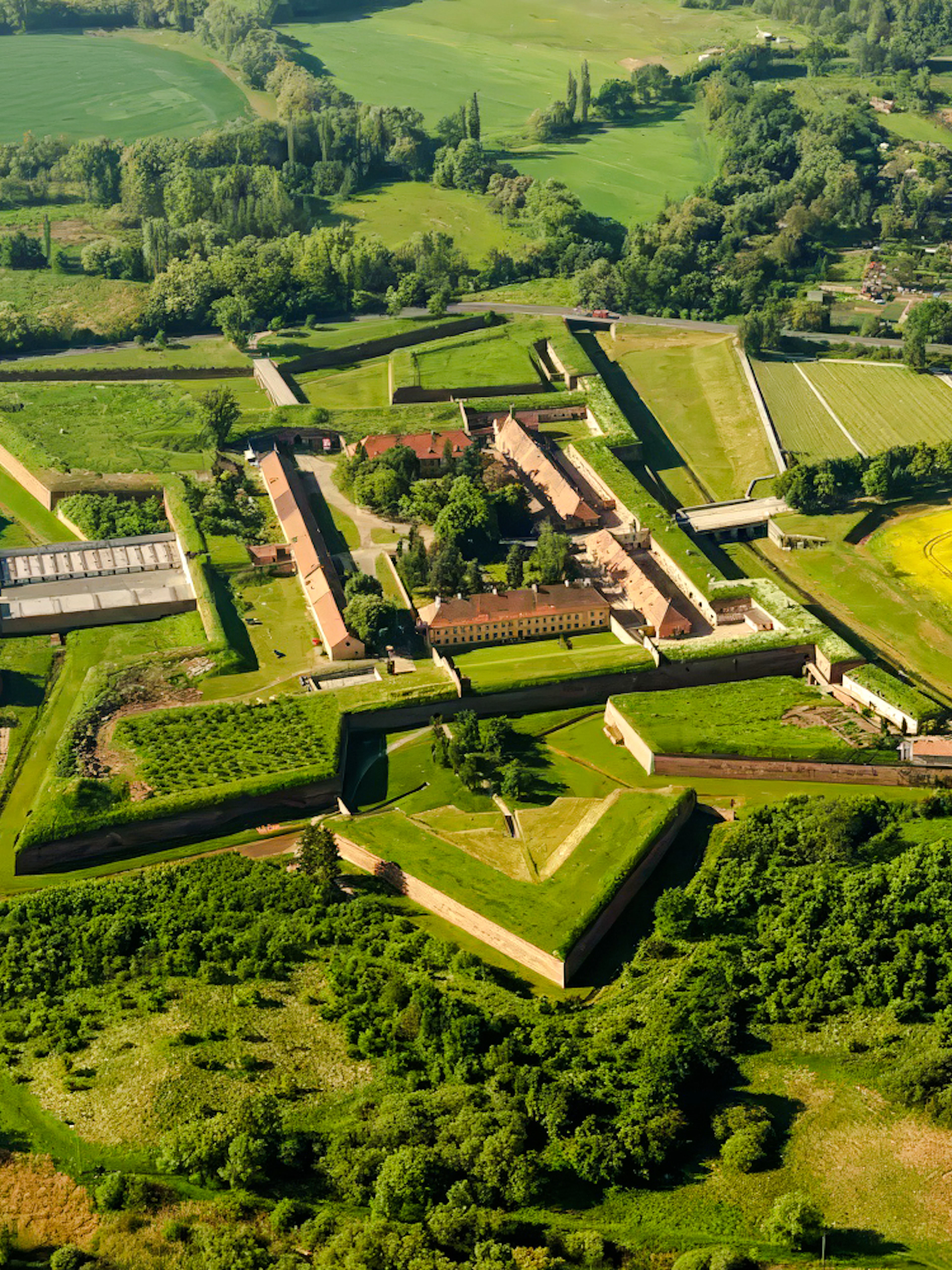 Aerial view of Terezín Concentration Camp surrounded by green fields near Prague.