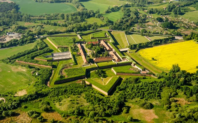 Aerial view of Terezín Concentration Camp surrounded by green fields near Prague.
