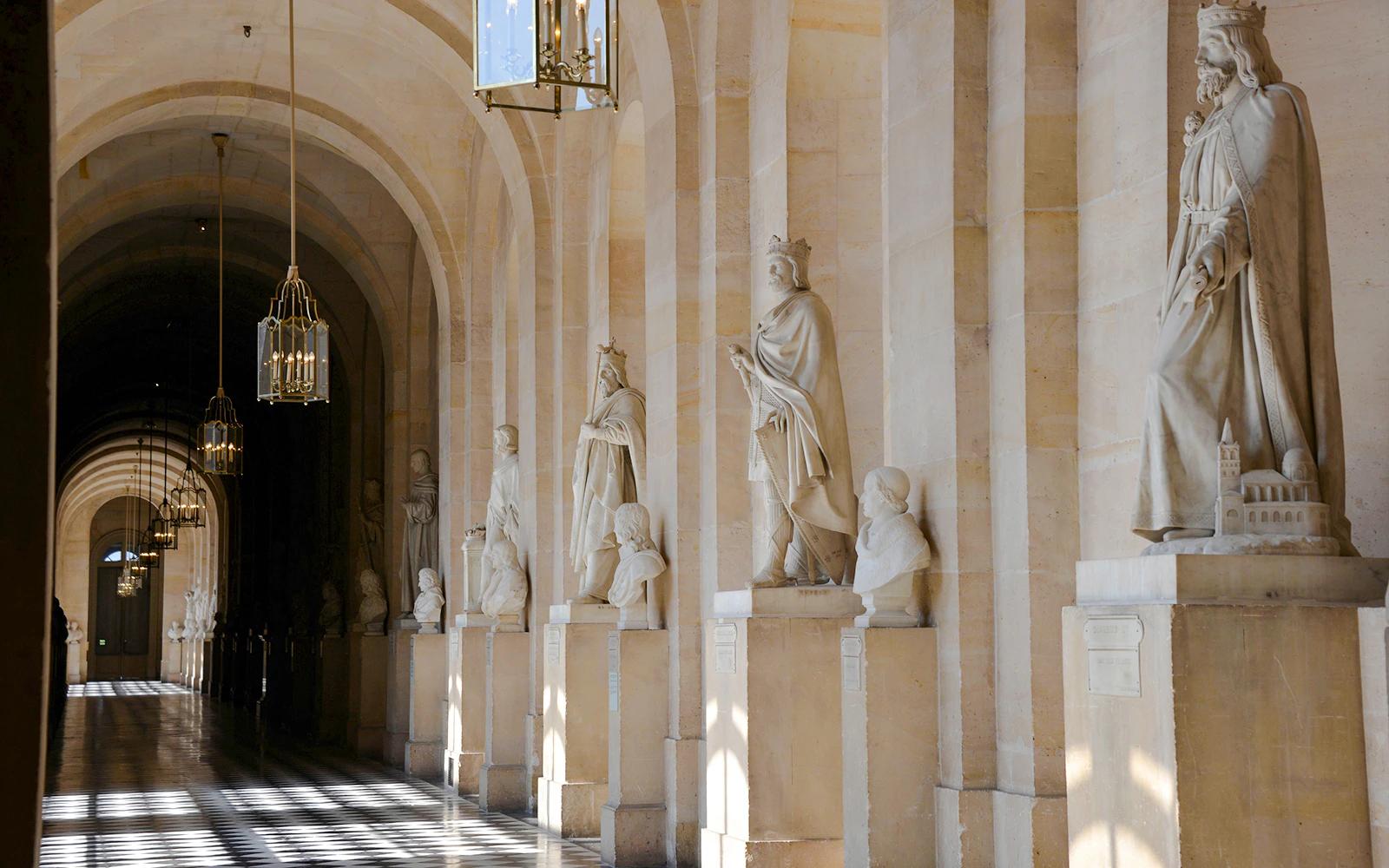 Statues lining a corridor at Versailles Palace, France.
