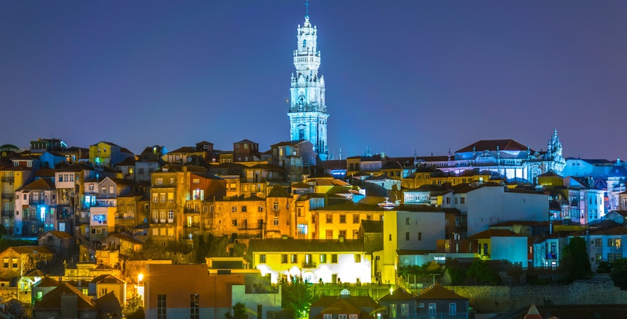 Night aerial view of Porto with Torre dos Clérigos tower illuminated, Portugal.