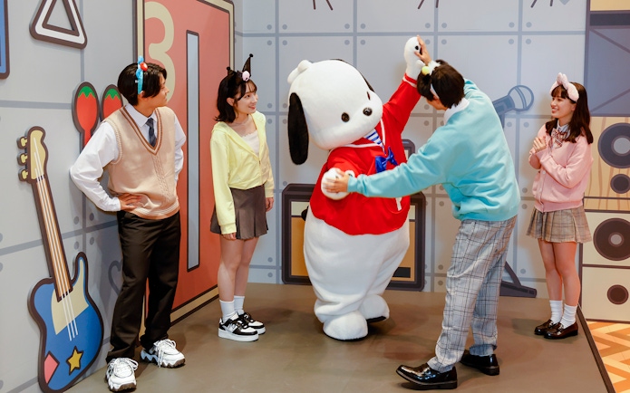 Visitors interacting with a character at Sanrio Puroland.