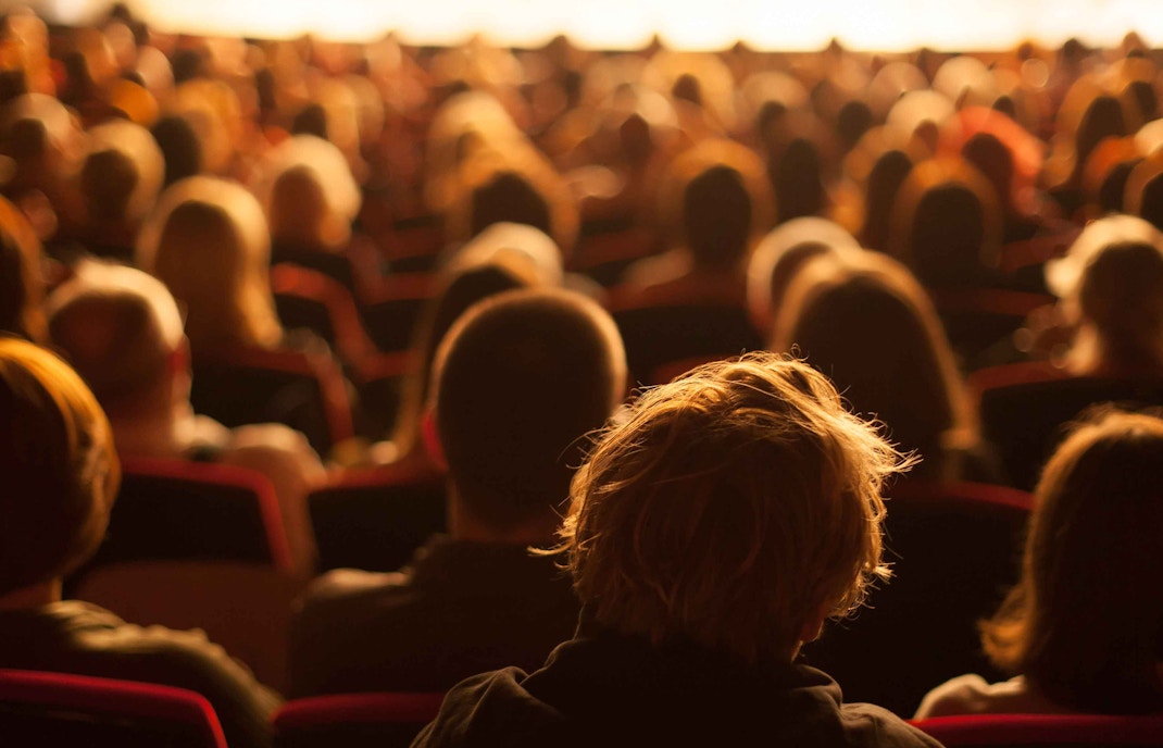Audience seated at Théâtre de la Ville, view from behind, booster seat unavailable.