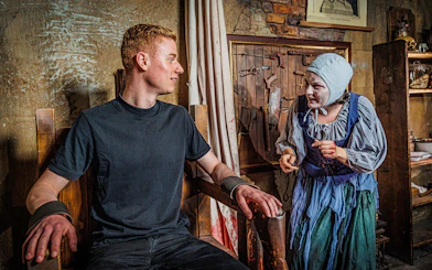 Visitor interacting with actor in historical costume at Berlin Dungeon.