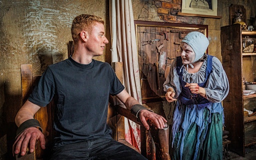 Visitor interacting with actor in historical costume at Berlin Dungeon.