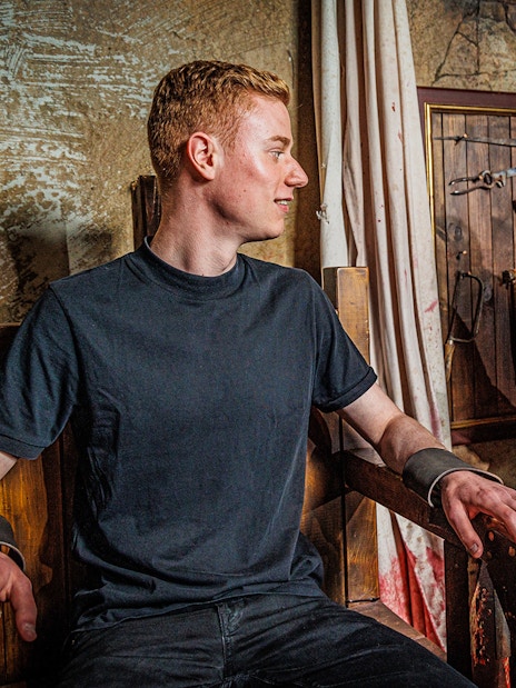 Visitor interacting with actor in historical costume at Berlin Dungeon.