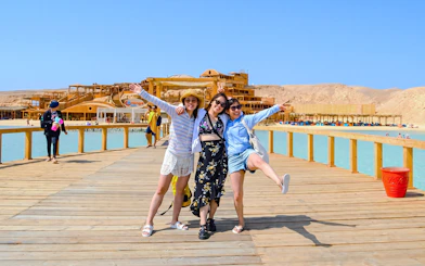 Friends enjoying a boardwalk at Orange Bay during a high-speed sea taxi tour.