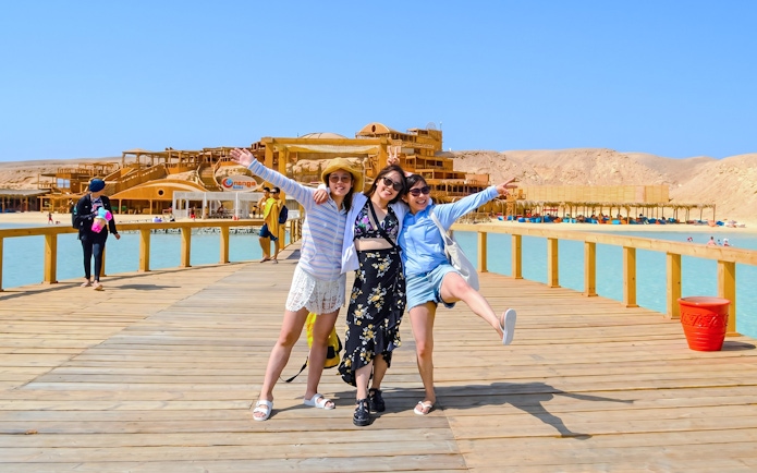 Friends enjoying a boardwalk at Orange Bay during a high-speed sea taxi tour.