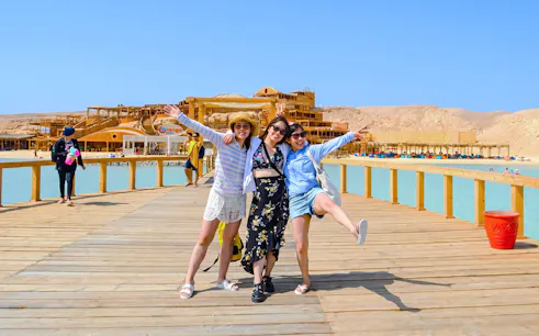 Friends enjoying a boardwalk at Orange Bay during a high-speed sea taxi tour.