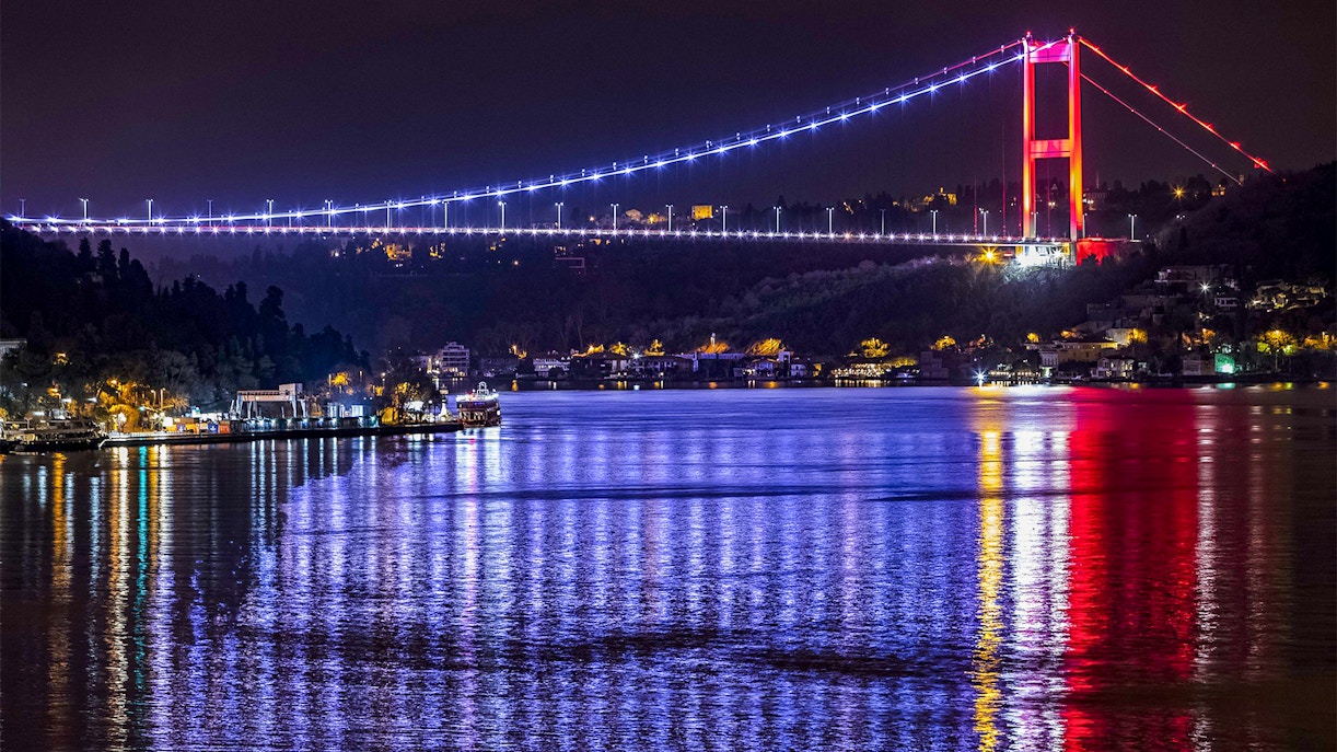 Bosphorus Bridge illuminated at night over the Bosphorus Strait, Istanbul.