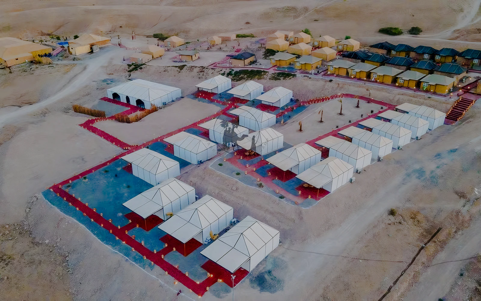 Aerial view of Agafay desert camp with white tents near Marrakech.