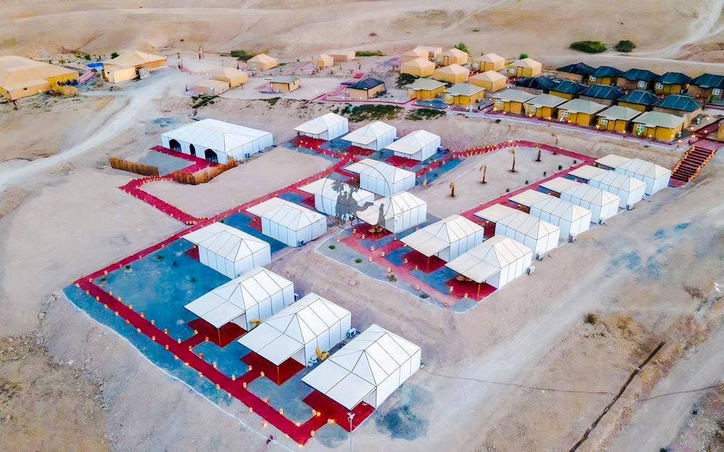 Aerial view of Agafay desert camp with white tents near Marrakech.