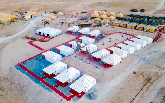 Aerial view of Agafay desert camp with white tents near Marrakech.