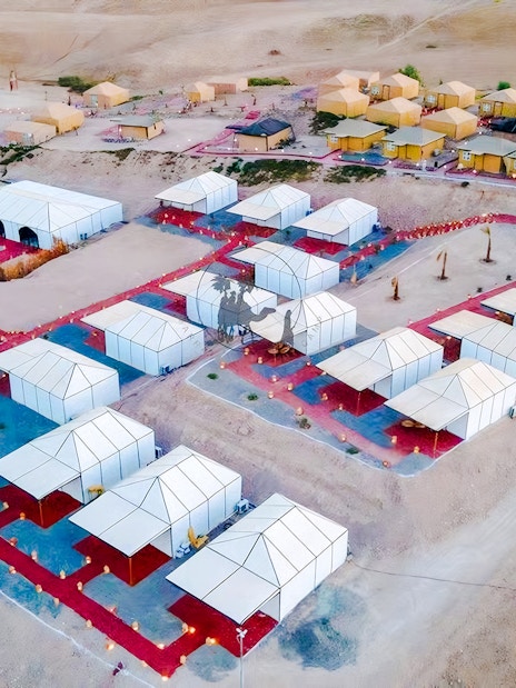 Aerial view of Agafay desert camp with white tents near Marrakech.