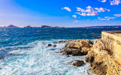 Frioul Archipelago view with Châteaux d’If in the distance, rocky coastline in Marseille.