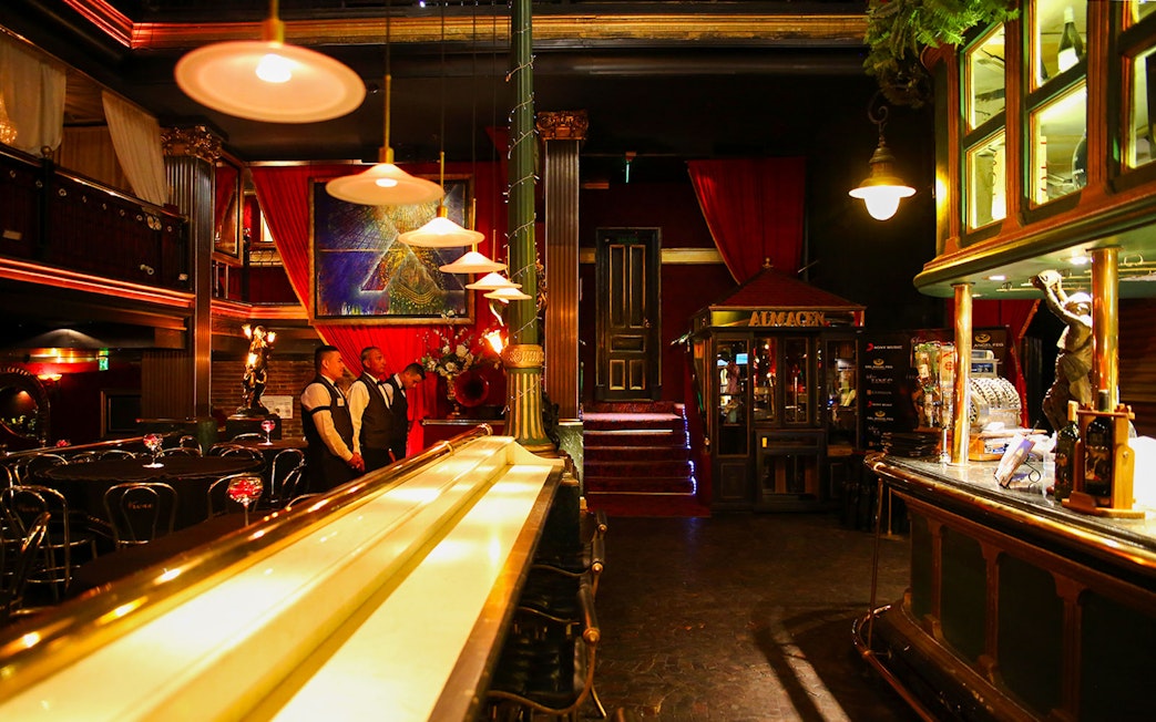 Bar and dining area at Señor Tango Show with staff and elegant decor.