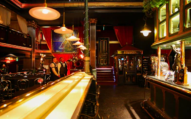 Bar and dining area at Señor Tango Show with staff and elegant decor.