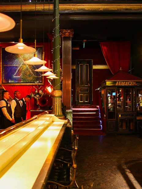 Bar and dining area at Señor Tango Show with staff and elegant decor.