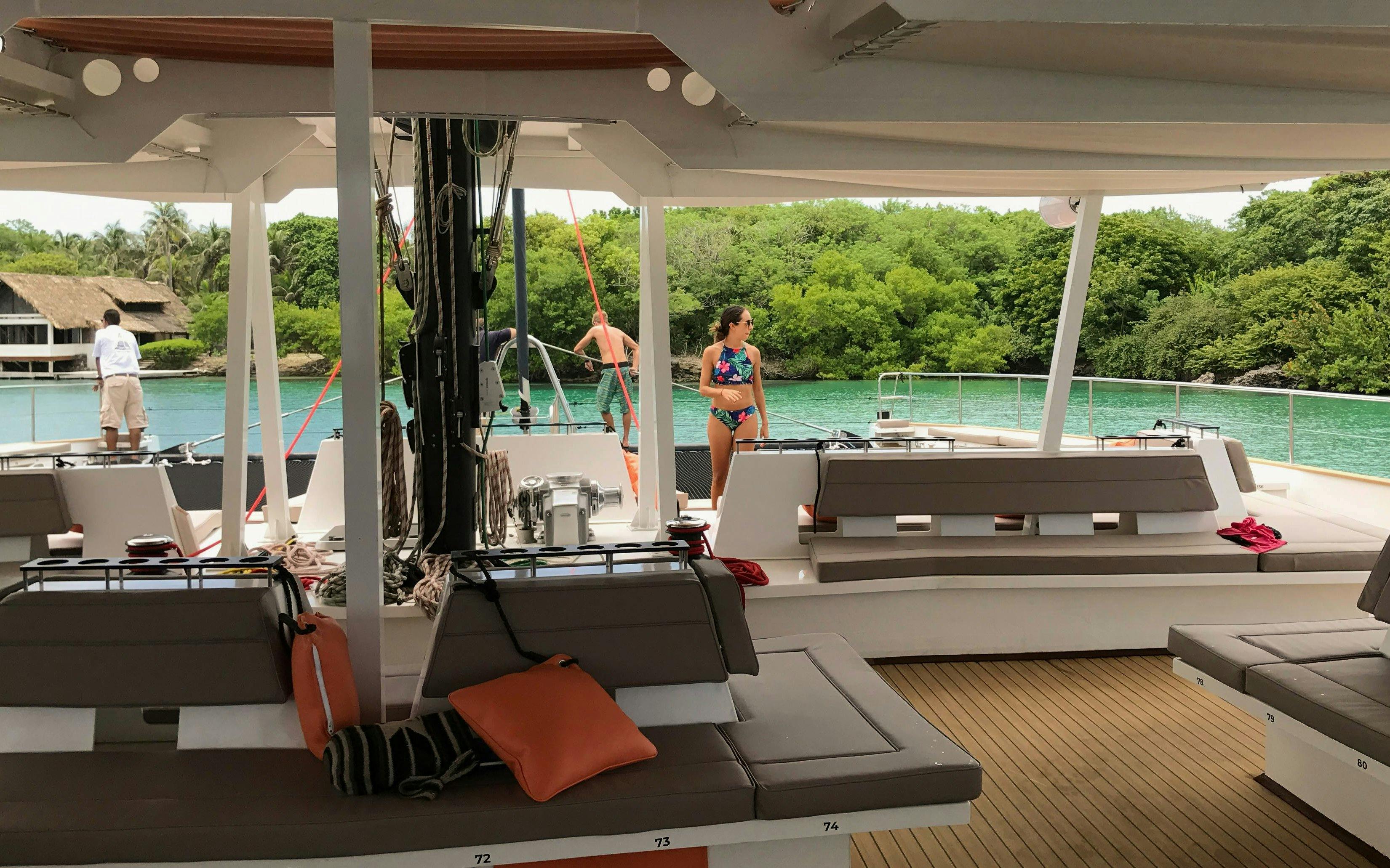 Catamaran deck with open bar and tourists enjoying the view in Cartagena.