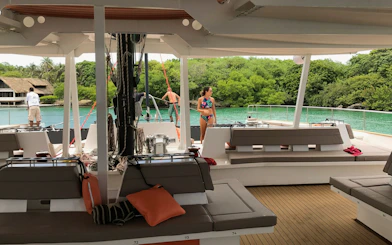 Catamaran deck with open bar and tourists enjoying the view in Cartagena.