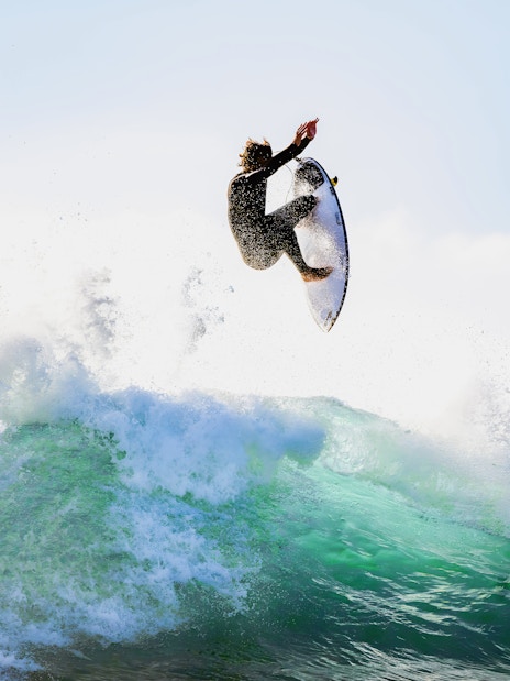 Tourist surfing a wave in Lisbon, Portugal.