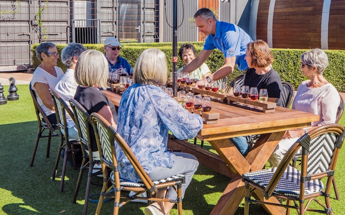 Group enjoying wine tasting at Sunshine Coast Hinterland tour.