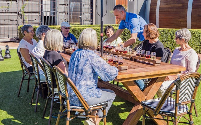 Group enjoying wine tasting at Sunshine Coast Hinterland tour.
