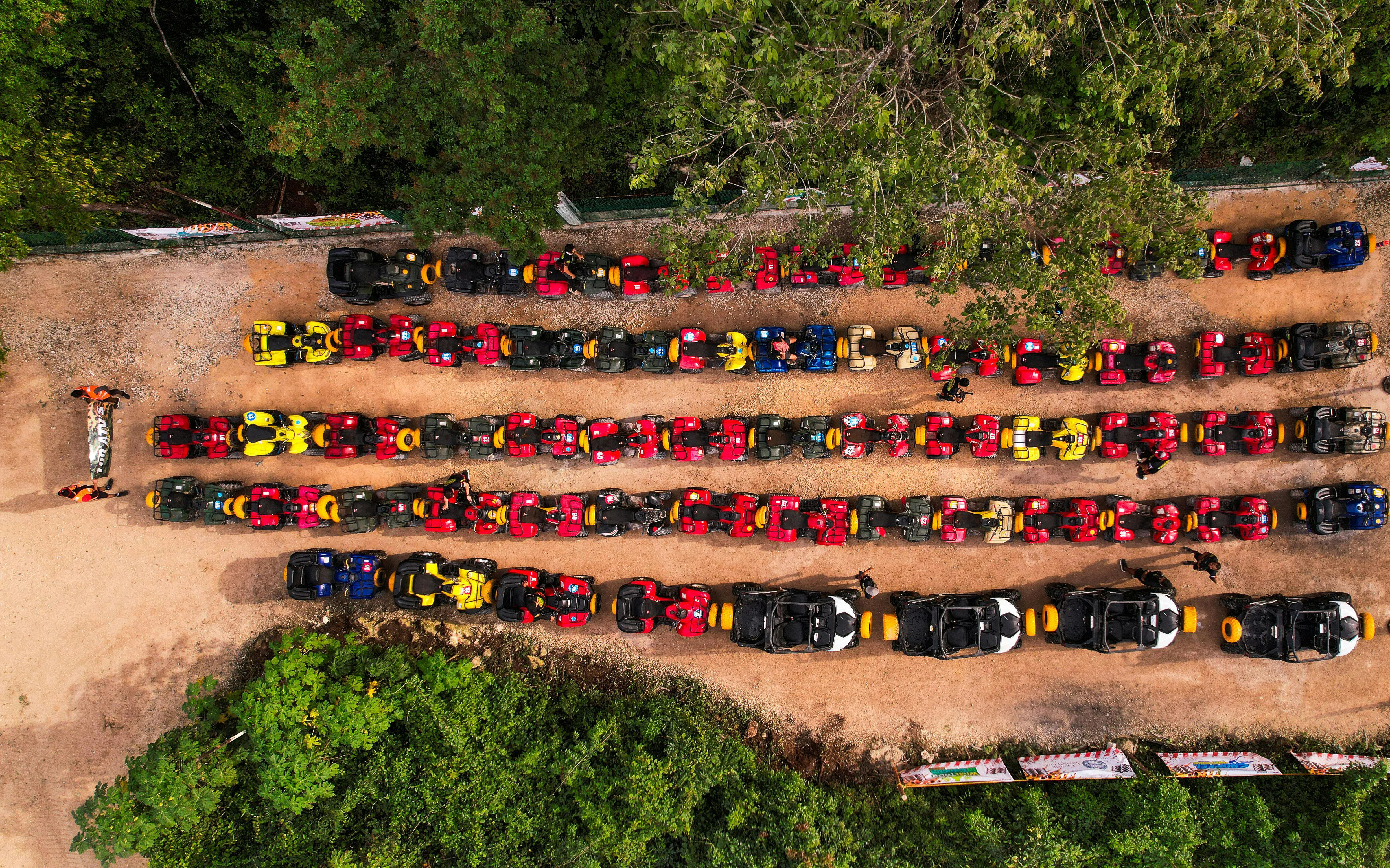 ATVs lined up at Cancun Extreme Adventuring Park, ready for tours with ziplines and cenote.