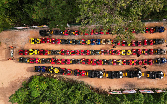ATVs lined up at Cancun Extreme Adventuring Park, ready for tours with ziplines and cenote.