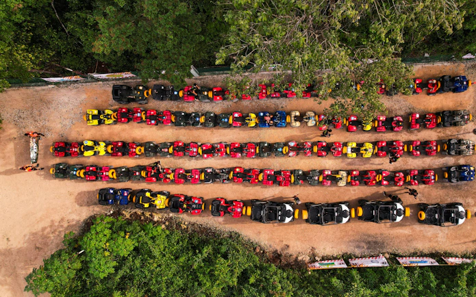 ATVs lined up at Cancun Extreme Adventuring Park, ready for tours with ziplines and cenote.