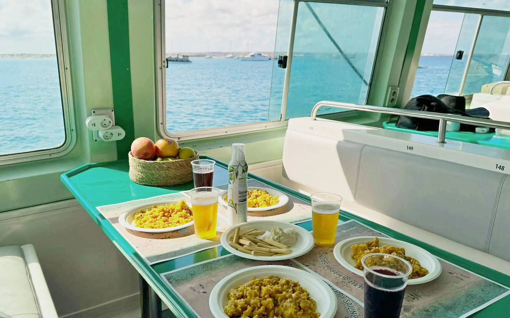 Lunch setup on Ibiza to Formentera cruise with paella and drinks by the sea.