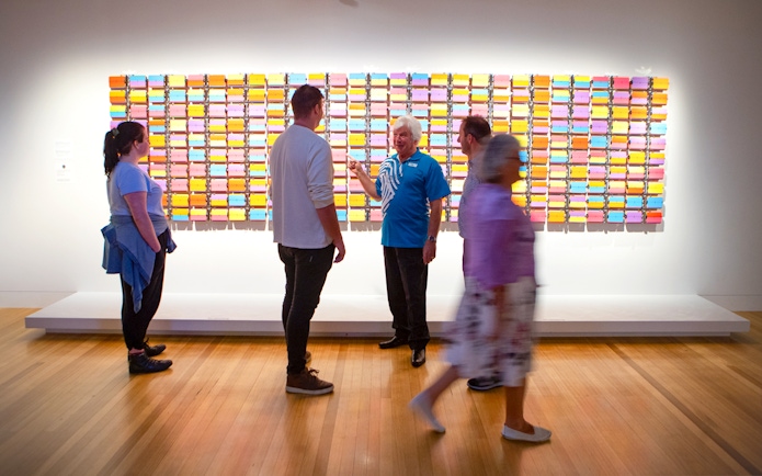 Visitors viewing colorful art installation at Museum of NZ Te Papa Tongarewa.