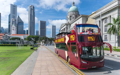 Singapore Hop-On-Hop-Off bus near National Gallery with city skyline.