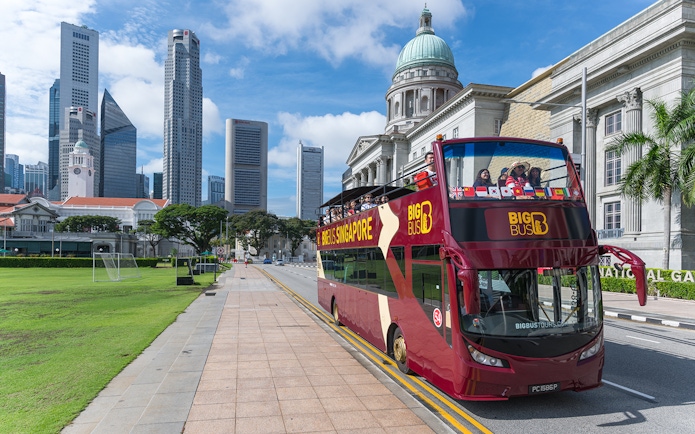 Singapore Hop-On-Hop-Off bus near National Gallery with city skyline.