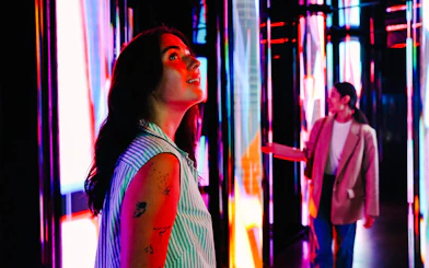 Visitors exploring vibrant light displays at Edge NYC Observation Deck.