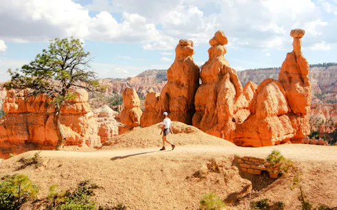 Person walking among hoodoos in Bryce Canyon National Park, Utah.