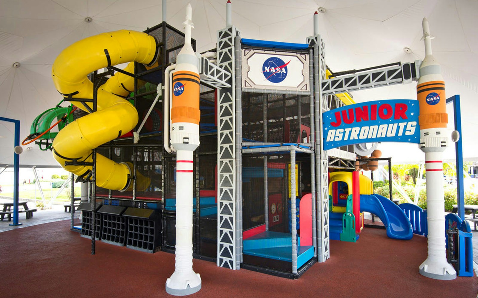 Junior Astronauts play area with slides and NASA-themed structures at Planet Play.