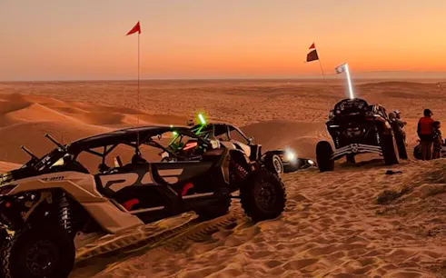 Buggy ride at sunset in Marrakech Palmeraie desert with group of people.