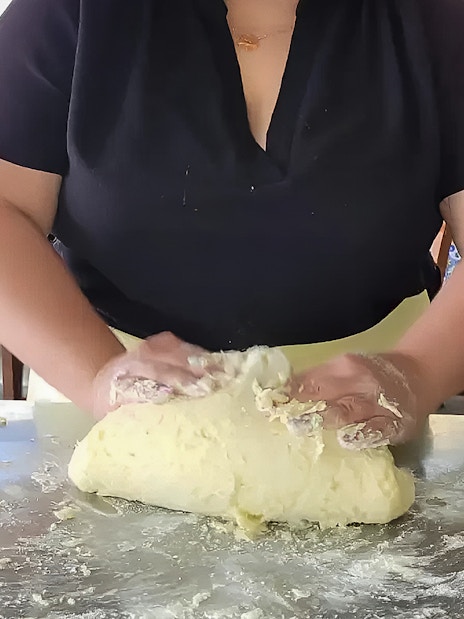Person kneading dough in Amalfi Coast cooking class.