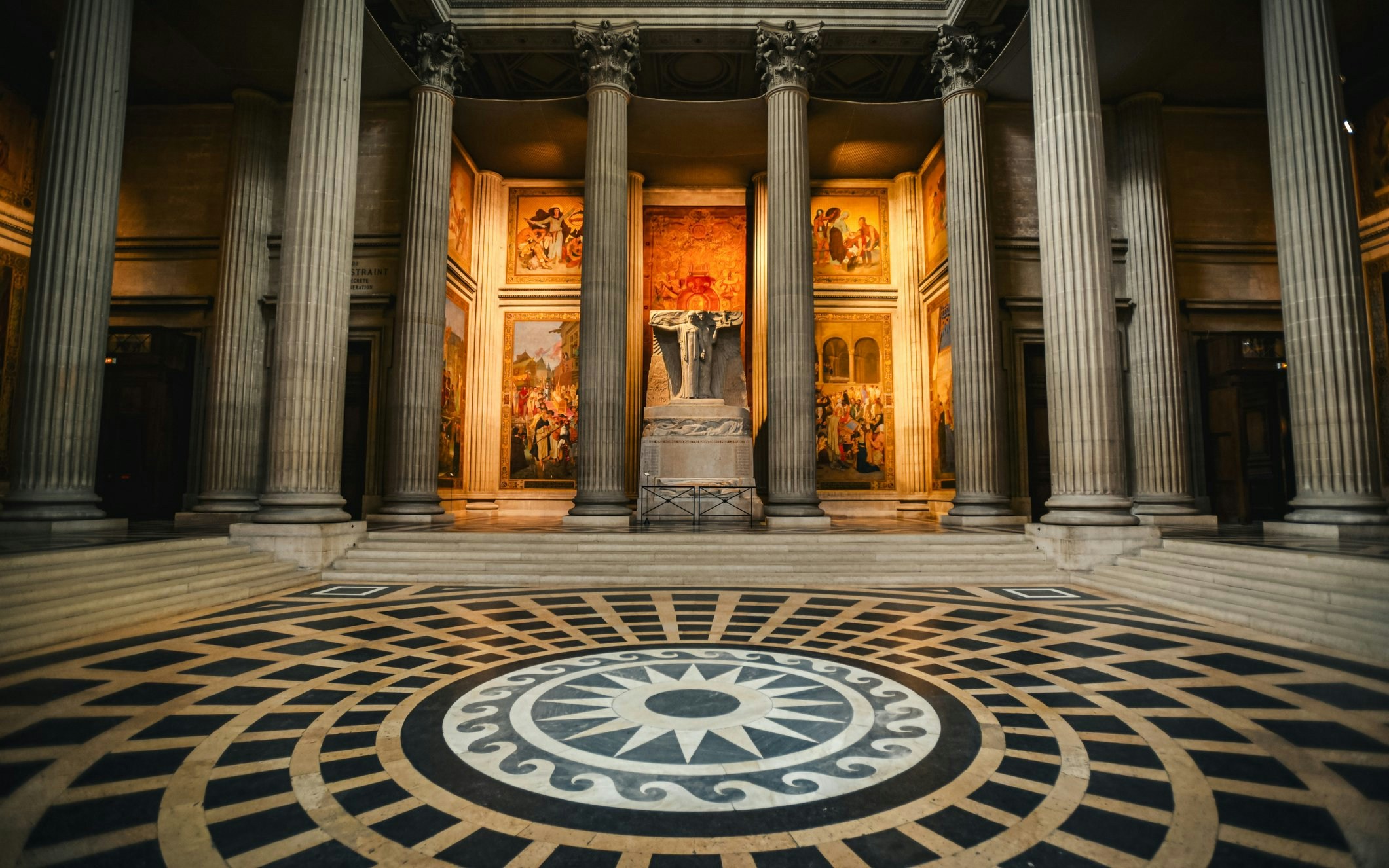 Interior of Paris Pantheon with columns and detailed murals.