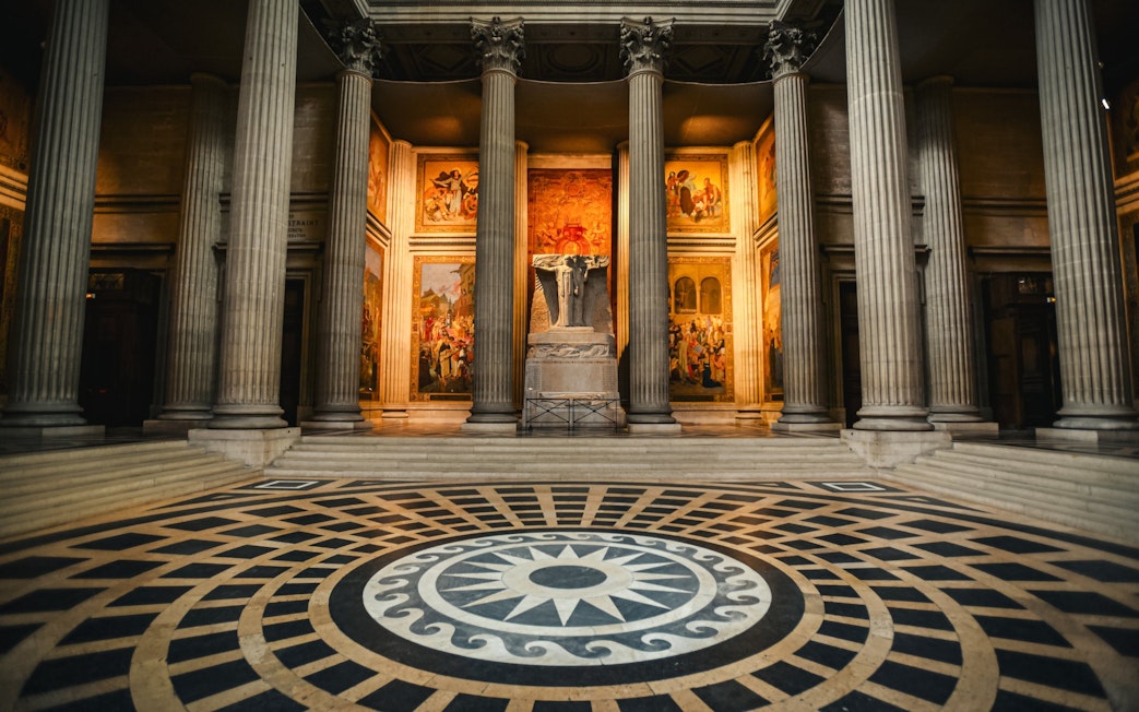 Interior of Paris Pantheon with columns and detailed murals.