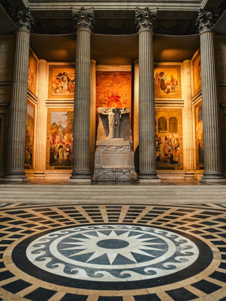 Interior of Paris Pantheon with columns and detailed murals.