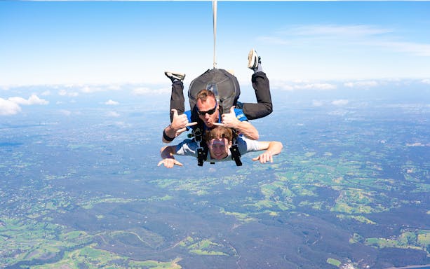 Tandem skydive over Yarra Valley with expansive landscape view below.