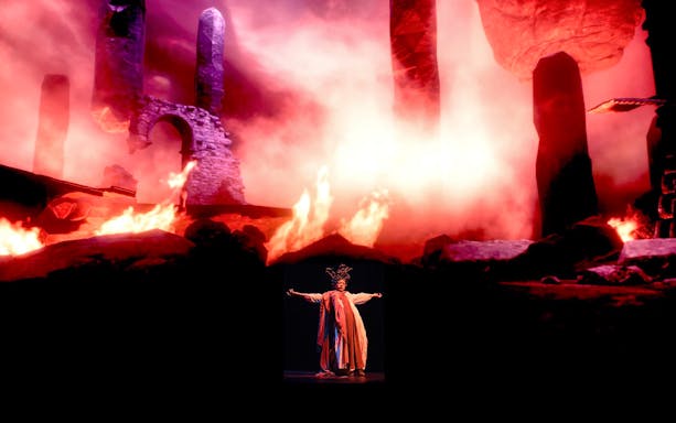Performers on stage with fiery backdrop at Legends of Istanbul show.